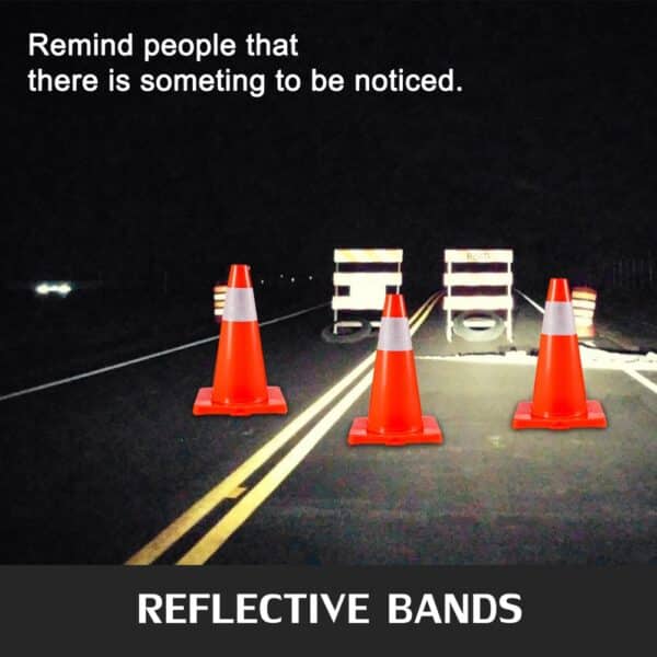 VEVOR traffic cones with reflective bands on a dark road with barriers.