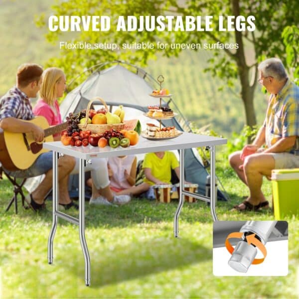 VEVOR stainless steel kitchen island with curved adjustable legs in outdoor picnic setting.