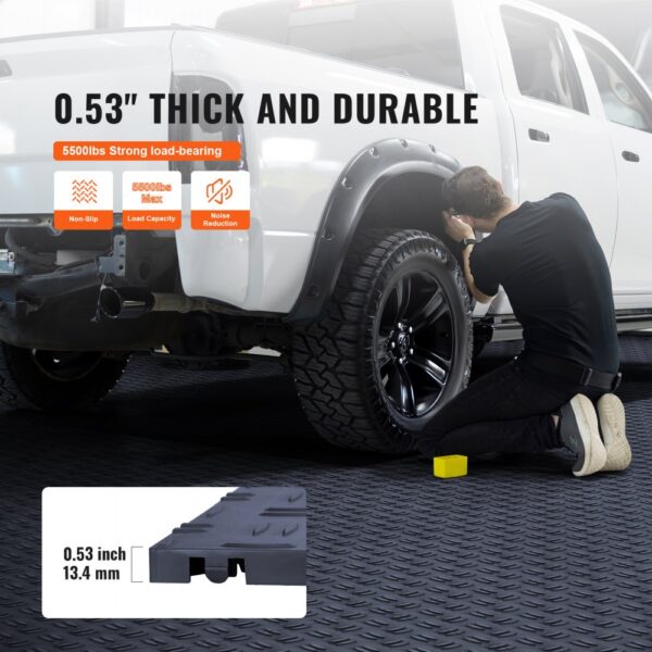 man working on a truck in a garage with durable 0.53" VEVOR garage tiles designed for high load capacity.