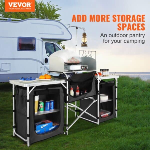 VEVOR camping kitchen table set up near a camper van with multiple storage shelves, pantry, and a grilling area.