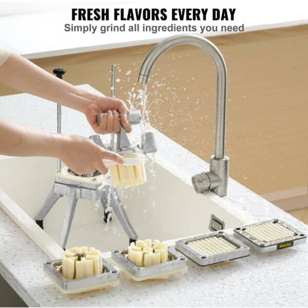 hands washing VEVOR vegetable chopper parts under a faucet with two grid accessories on a countertop.