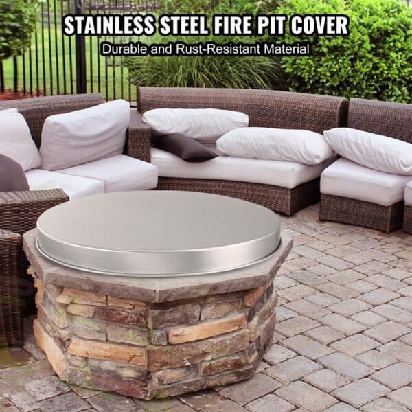 stainless steel VEVOR fire pit cover protecting a stone fire pit in an outdoor patio area.