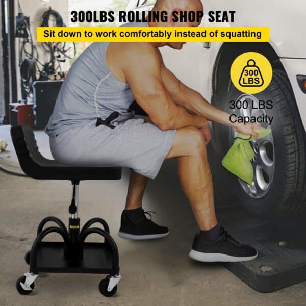 man cleaning car wheel on VEVOR rolling garage stool, 300lbs capacity, black seat with wheels.