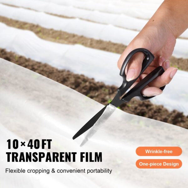 person cutting VEVOR greenhouse plastic sheeting with scissors on a farm; 10x40ft transparent film.