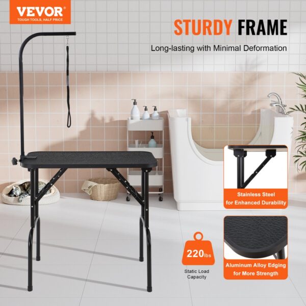 VEVOR pet grooming table with sturdy frame, stainless steel, and aluminum alloy edging in a tiled room.