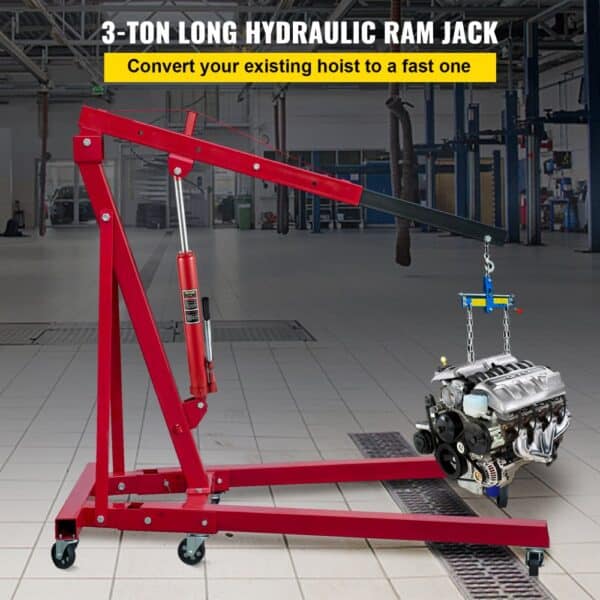 VEVOR hydraulic ram jack lifting an engine in a spacious workshop.