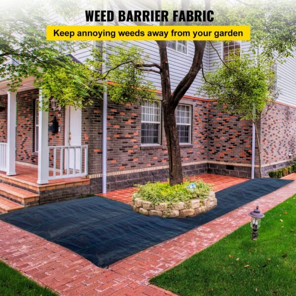 VEVOR weed barrier fabric on brick pathway surrounding garden in front of house.