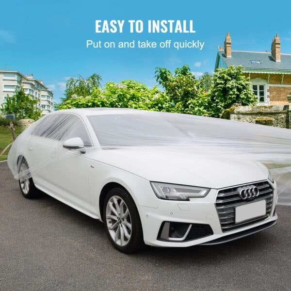 VEVOR car cover on white audi, quick to install, with greenery and buildings in the background.