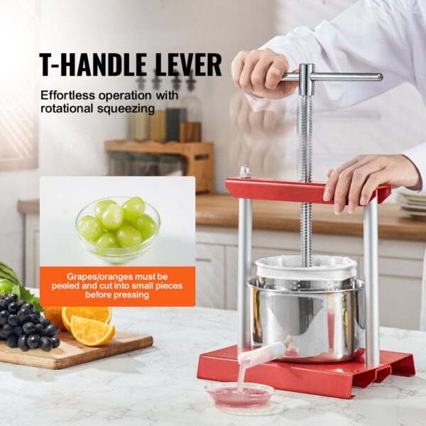 VEVOR fruit wine press with t-handle in kitchen, squeezing grapes beside sliced oranges and grapes.